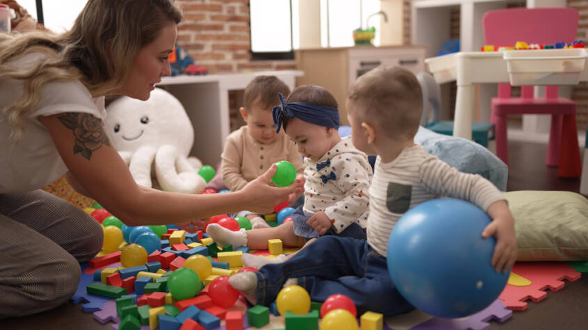 teacher taking care of children in play school