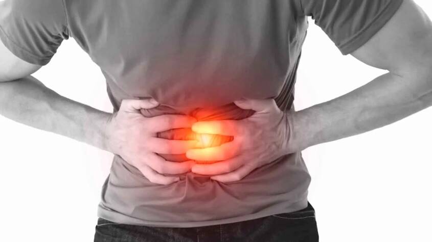 Doctor evaluating abdominal pain symptoms in a patient.